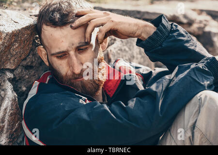 Portrait of sad homeless man outdoors Stock Photo