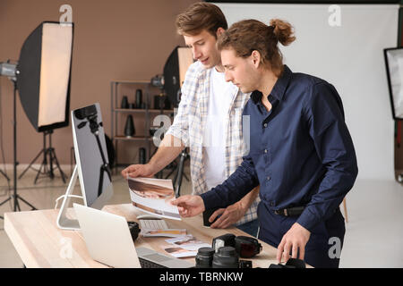 Professional photographers working in modern studio Stock Photo