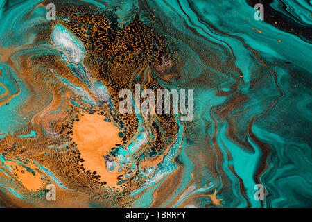 Acrylic Fluid Art. Spots of red gold and aquamarine waves. Abstract stone background or texture. Stock Photo