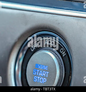 Square frame Close up view of an engine push start and stop button inside a vehicle Stock Photo