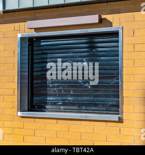 Square Exterior of a commercial building lit by sunlight on a sunny day Stock Photo