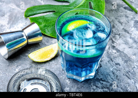 Tasty refreshing cocktails.Blue alcoholic cocktail with ice and lime