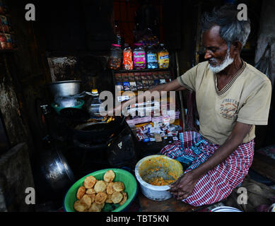 A Bangladeshi man cooking Puri Vaja in a small stall in Dhaka, Bangladesh. Stock Photo