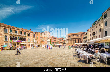 VENEZIA, ITALY – MAY 31, 2019: tourists visiting the city and enjoying Campo Santo Stefano, typycal square of Venice, and its bars Stock Photo