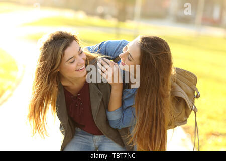 Funny friends meeting and joking in the street at sunset Stock Photo