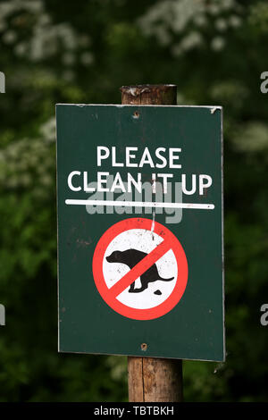 A Please clean it up sign asking dog owners to clean up after their pets, London, UK. Stock Photo