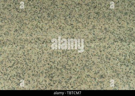 The structure of gray-beige granite. A natural stone. Industrial granite worktop in the restaurant Stock Photo