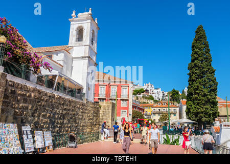 Tourists visiting to Largo das Portas do Sol viewpoint in historic Alfama district. Lisbon, Portugal Stock Photo