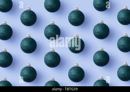 Green Christmas baubles organized over blue background, top view Stock Photo