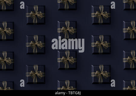 Multiple black gift boxes organized over black background, top view Stock Photo
