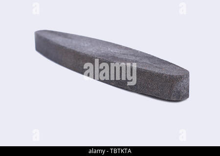 Whestone sharpener isolated on white background. Gray sharpening stone. Stock Photo