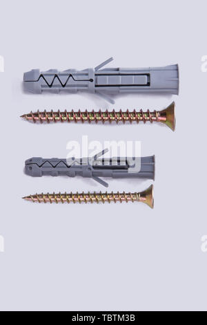 Screws and dowels on white background. Self-tapping screw and dowel. Tools for wood work. Stock Photo