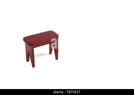 miniature figurine wooden piano bench isolated on white background. Stock Photo