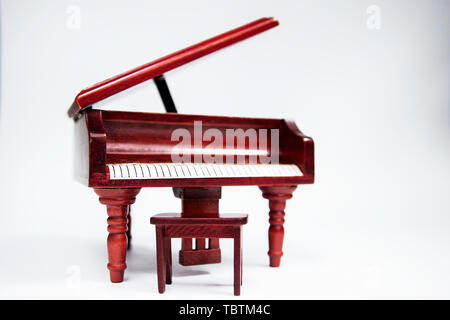 miniature classic piano keyboard instrument isolated on white background. Stock Photo
