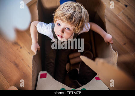 A top view of toddler boy playing indoors at home. Copy space. Stock Photo