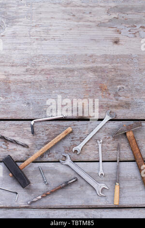 Construction tools on wooden boards. Hammer, spanners and other instruments for repair. Top view with copy space. Stock Photo