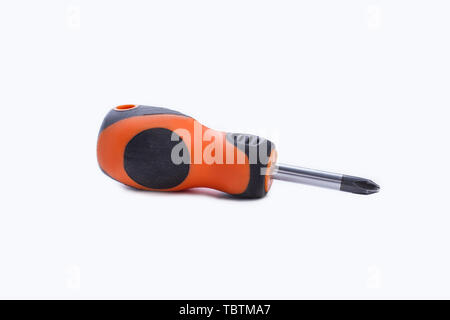Manual screwdriver with rubber handle. Small screwdriver isolated on white background. Stock Photo