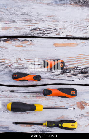 Set of various screwdrivers on wooden background. A new set of screwdrivers on wooden boards. Top view and copy space. Stock Photo