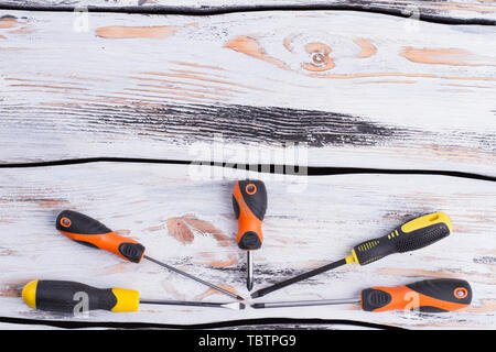 A new set of screwdrivers with copy space. Set of hand tools on wooden table. Flat lay composition. Stock Photo