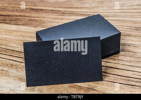 Stack of blank black business cards on wooden background Stock Photo