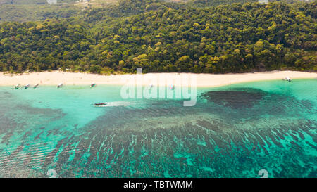 Puka Shell Beach, Boracay Island, Philippines, aerial view. Tropical white sand beach and beautiful lagoon. Tourist boats and people on the beach. People relax on the beautiful coast. Stock Photo