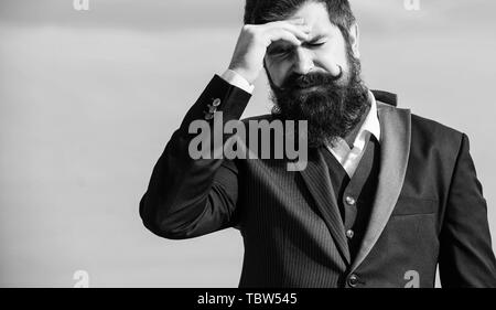 Business failure. Man bearded stressful painful face sky background. Guy suffer headache stressful day. Stressful business. Pain and migraine. Frustration and disappointment. Unforgivable mistake. Stock Photo