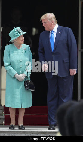 US President Donald Trump is welcomed by Queen Elizabeth II during the Ceremonial Welcome at Buckingham Palace, London, on day one of his three day state visit to the UK. Stock Photo