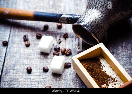 Fresh coffee in cezve on wooden table Stock Photo