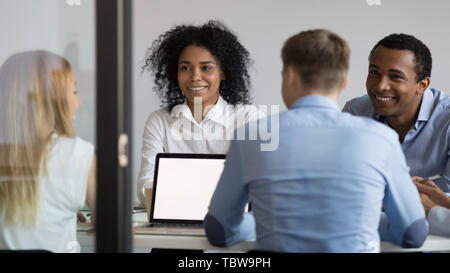 Multiracial businesspeople sitting in boardroom, discussing project, strategy Stock Photo