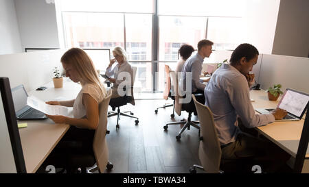 Diverse business people working in office, using computers, workday Stock Photo
