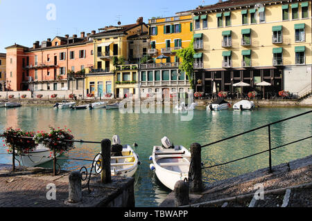 Beautiful morning in Peschiera del Garda town. Colorful houses, architecture view with boats. Little town harbour. Italian lake lago di Garda, Veneto 