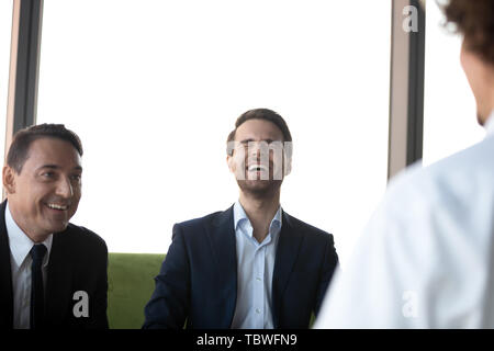 Job applicant make good first impression on laughing employers Stock Photo