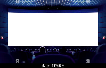 White screen in the cinema and the audience watching the movie. Cinema. Stock Photo