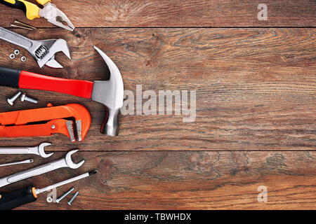 Assorted work tools on wooden background with copy space Stock Photo
