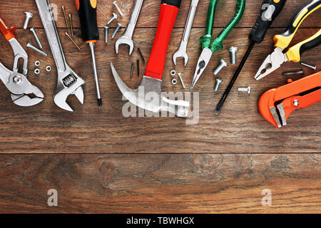 Assorted work tools on wooden background with copy space Stock Photo