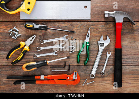 Assorted work tools on wooden background Stock Photo