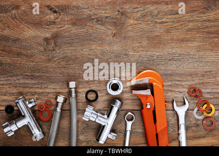 Set of plumbing tools on wooden table background. Close up top down view with copy space. Stock Photo