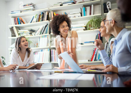 Programmers cooperating at IT company developing apps Stock Photo
