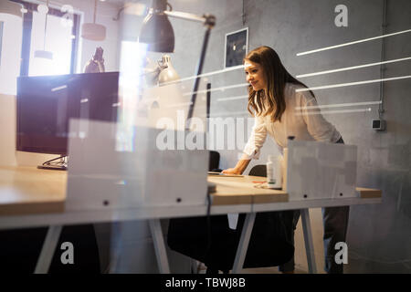 Portrait of young frustrated businesswoman overworked in office Stock Photo