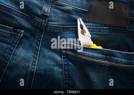 Pliers in the back pocket of a blue jean. Concept of working class and mechanic repairman. Close up view. Stock Photo