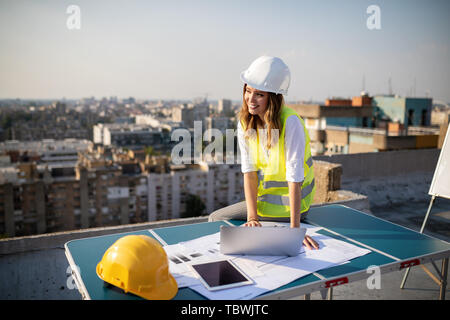 Young woman architect, construction engineer at a construction site Stock Photo