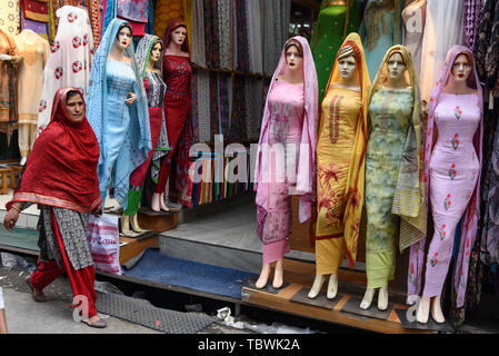 Clothes seen being displayed at a shop ahead of Eid-ul-Fitr festival which marks end of the Holy fasting month of Ramadan in Srinagar. Stock Photo