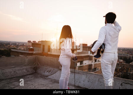 Fencing athletes people practicing outdoor on rooftop Stock Photo