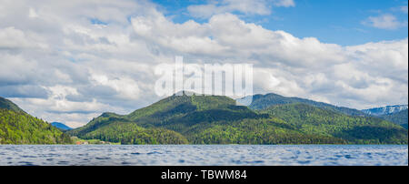 cloudy sky, beautiful mountains, wavy water Stock Photo