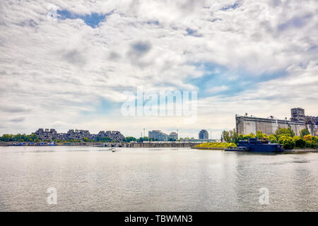 Montreal, Canada - June, 2018: Old port, saint lawrence river, Bota bota spa and historical grain factory silo No.5 in Montreal, Quebec, Canada. Edito Stock Photo