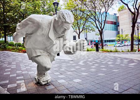 Montreal, Canada - June, 2018: Sculpture of a running man in a small park. Public art in Montreal, Quebec, Canada. Editorial. Stock Photo