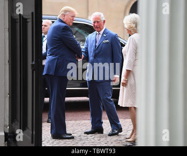 US President Donald Trump (left) arrives at Clarence House in London to take tea with the Prince of Wales and Duchess of Cornwall on the first day of his state visit to the UK. Stock Photo