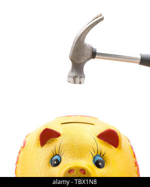 An old-fashioned hammer is about to hit a gold piggy bank Stock Photo ...