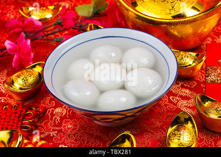 Chinese Lantern Festival food,ang pow or red packet and gold ingots. Chinese characters means luck,wealth and prosperity. Stock Photo