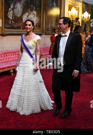 The Duchess of Cambridge and United States Secretary of the Treasury, Steven Mnuchin arrive through the East Gallery during the State Banquet at Buckingham Palace, London, on day one of the US President's three day state visit to the UK. Stock Photo